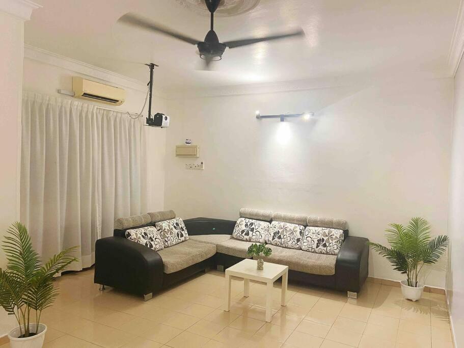a living room with a couch and a table at Homestay 2 @Taman Teluk Intan in Teluk Intan