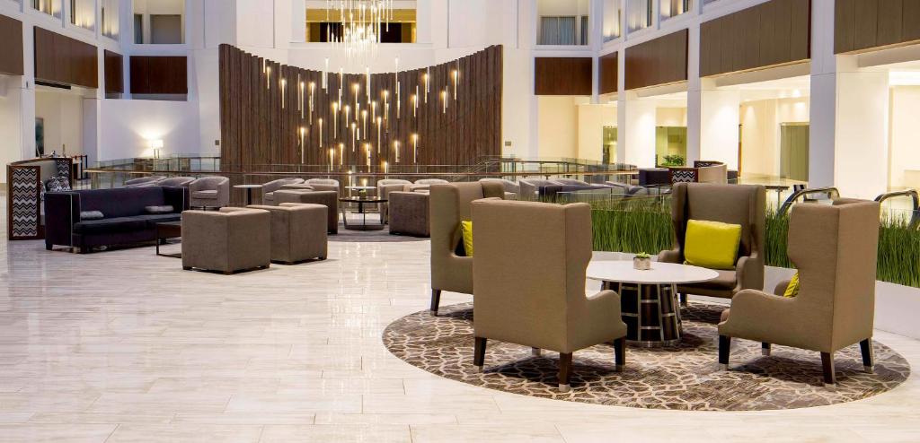 a hotel lobby with chairs and tables and a chandelier at Grand Hyatt Washington in Washington