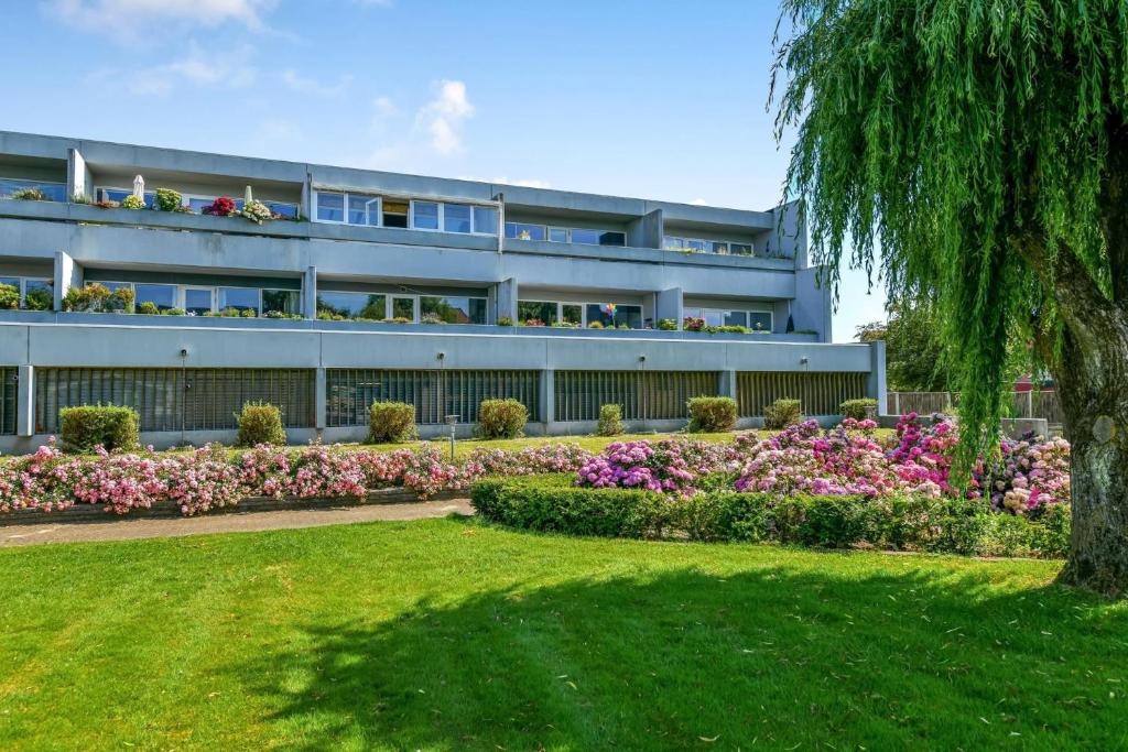 a large building with flowers in front of it at (Id 039) Rørkjærsgade 12 dor 209 in Esbjerg