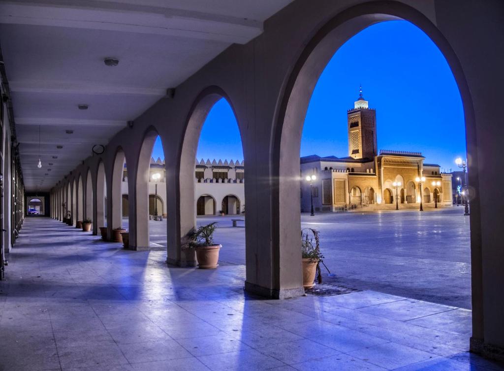 an empty courtyard with a clock tower in a building at oujda in Erfoud