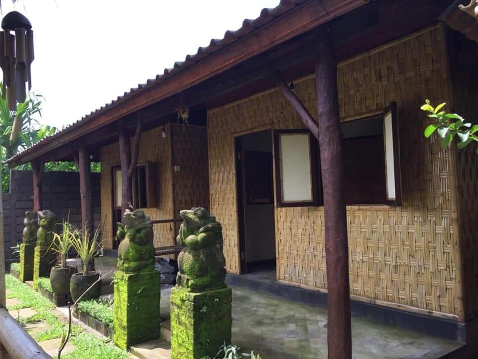 a house with statues of lions in front of it at BaliFarmhouse in Banjarangkan