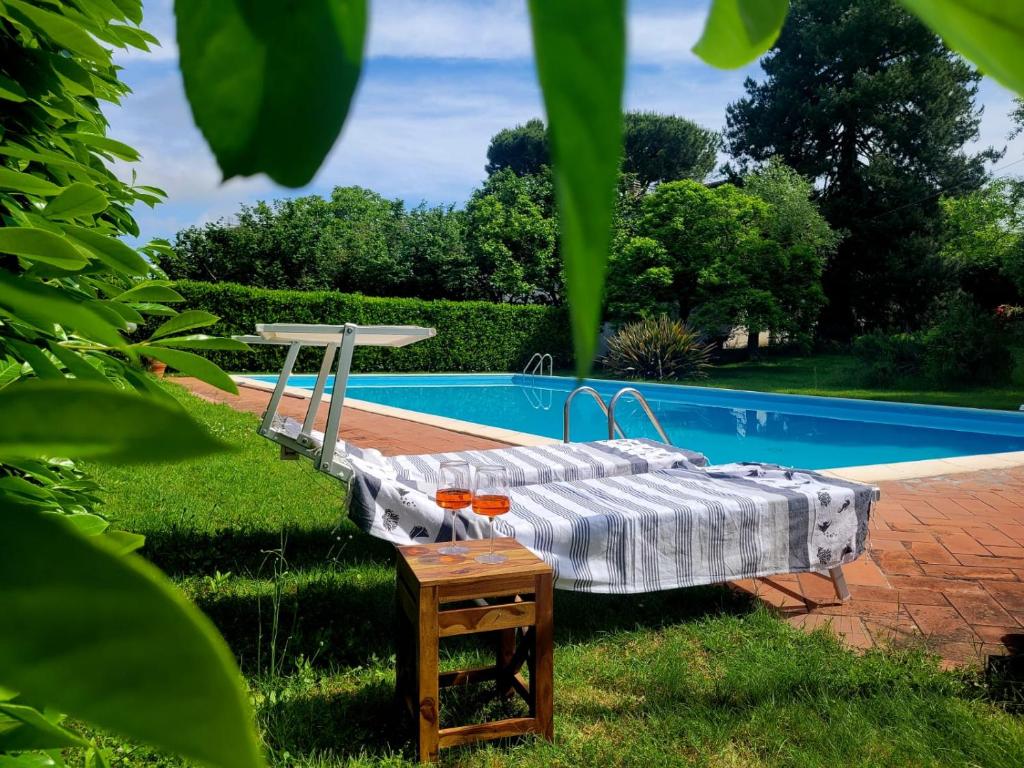a bed sitting next to a swimming pool at La Tenuta Del Conte in Soriano nel Cimino