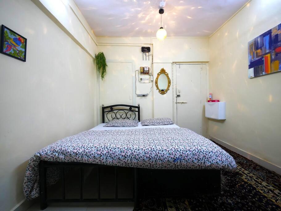 a bedroom with a large bed in a room at DawnsMelody in Mumbai