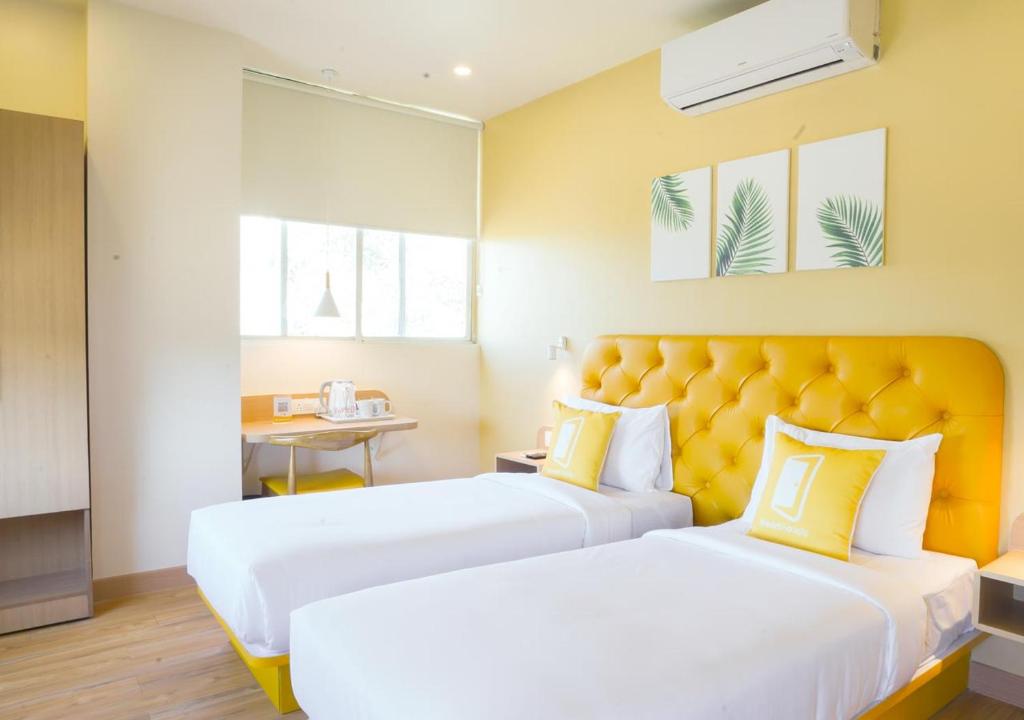 Postel nebo postele na pokoji v ubytování Bloom Hotel - Magarpatta