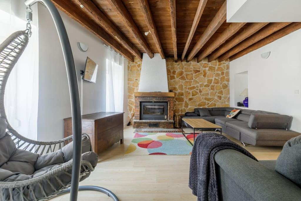 a living room with a couch and a fireplace at La Maison Coublandine in Coublanc
