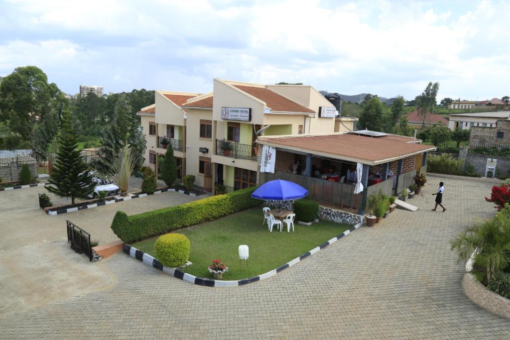 an overhead view of a house with a blue umbrella at Jatheo Hotel Rwentondo in Mbarara