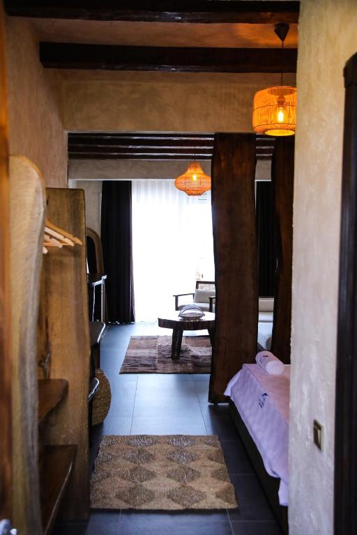a room with two bunk beds and a table at MAVİ AT HOTEL Blue Horse in Gümüşdere
