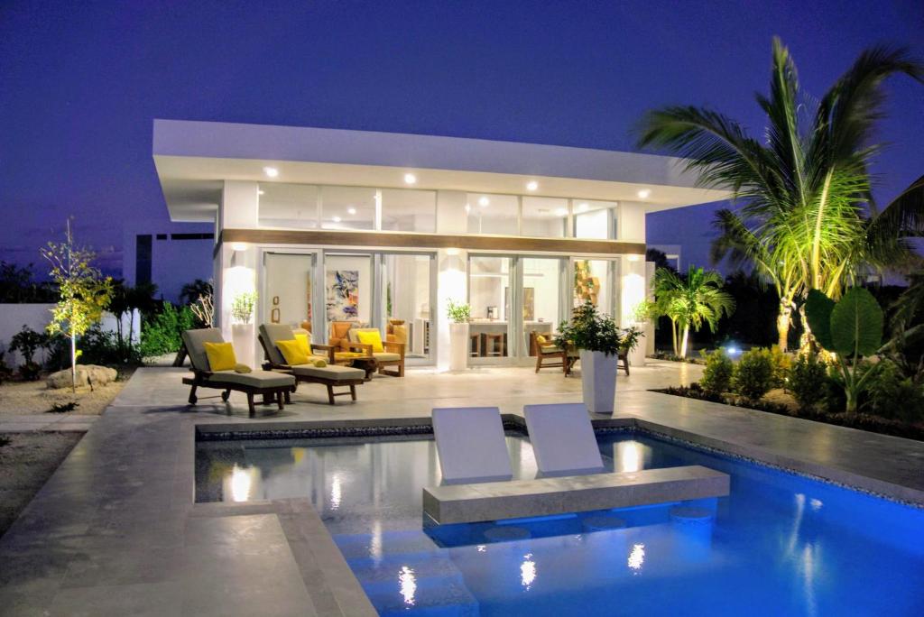 The swimming pool at or close to White Villas - Romantic Getaway - Oceanside Large Modern Studio with Pool, 500ft from Long Bay Beach