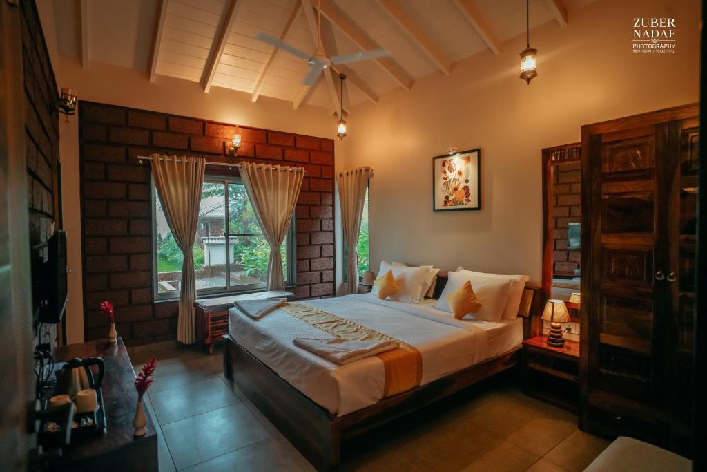 a bedroom with a large bed and a window at Kireina Wellness Resort in Koynanagar