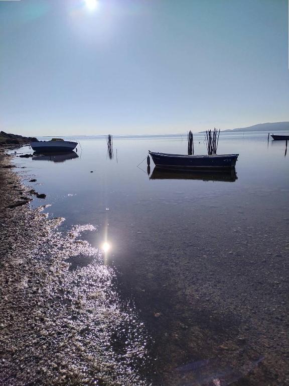 two boats are sitting in the water on the shore at Villa piscine privée superbe Vue Etang Leucate 8JBART580 in Port Leucate