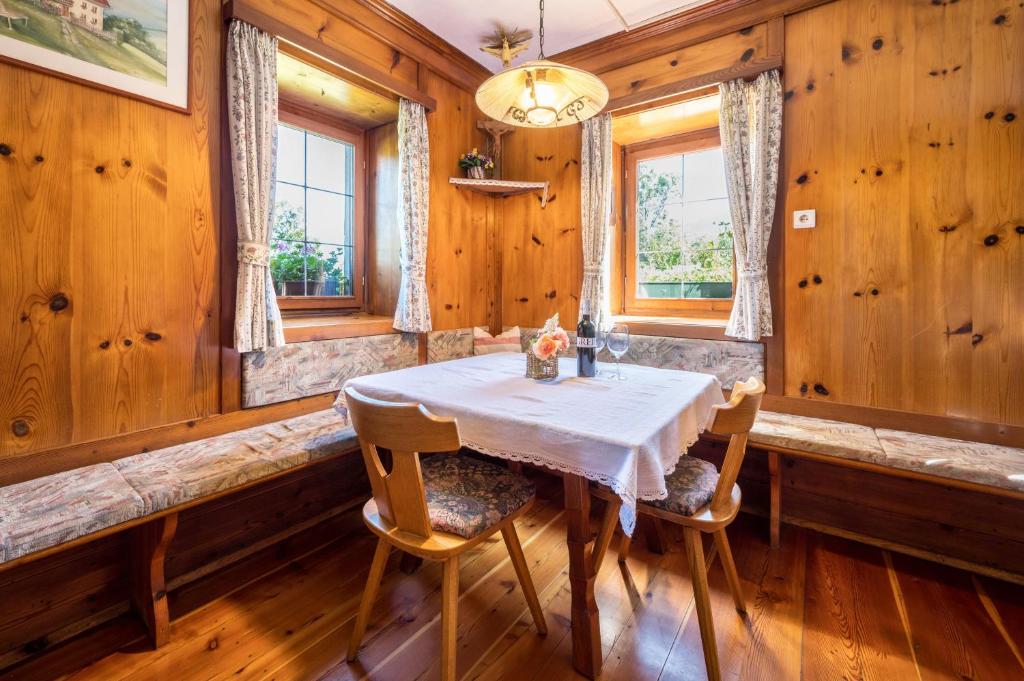 a dining room with a table and two chairs at Urthalerhof Historic in Valdaora