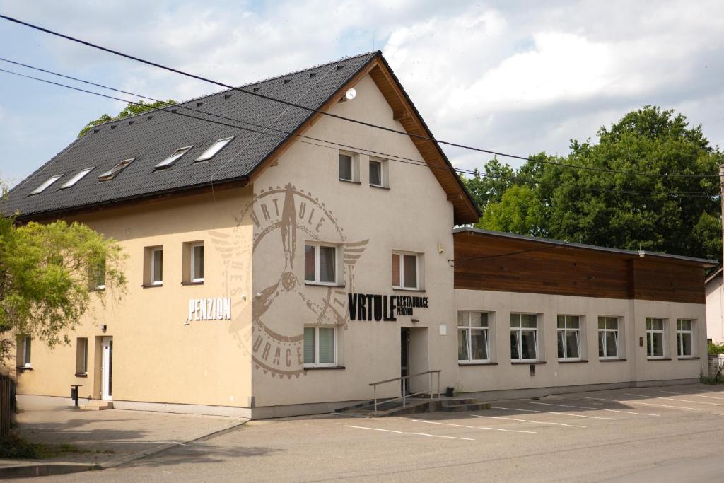 budynek z obrazem na boku w obiekcie Restaurace a penzion Vrtule w mieście Pietwałd