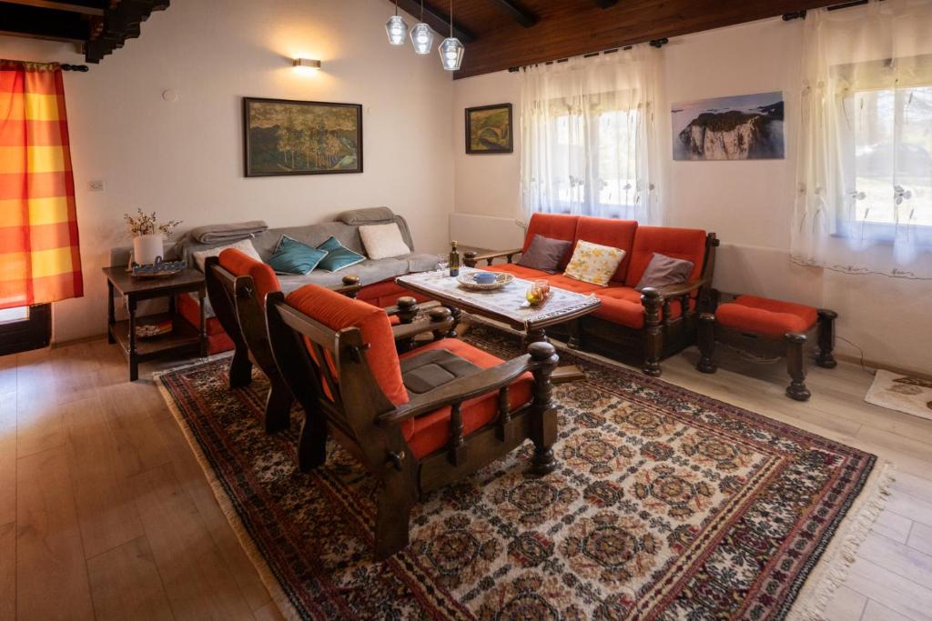 a living room with a couch and a table at Svjetlost in Jahorina