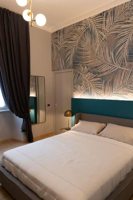 a bedroom with a large white bed with a wall at Spazio SIMA Space 2 - 2 in Milan