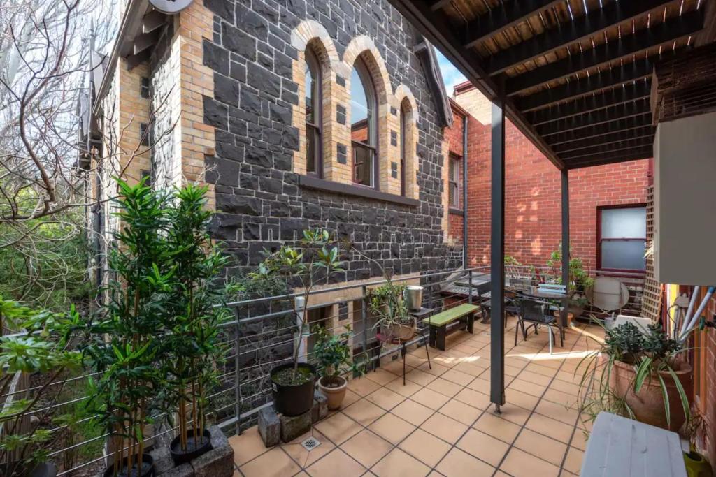 een patio met een bakstenen gebouw met planten bij Bright & Sunny 2-bed Unit in the heart of St Kilda in Melbourne