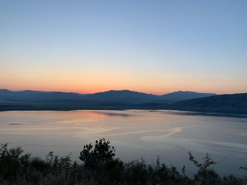 a view of a large body of water at sunset at Villas Ermali in Ksamil