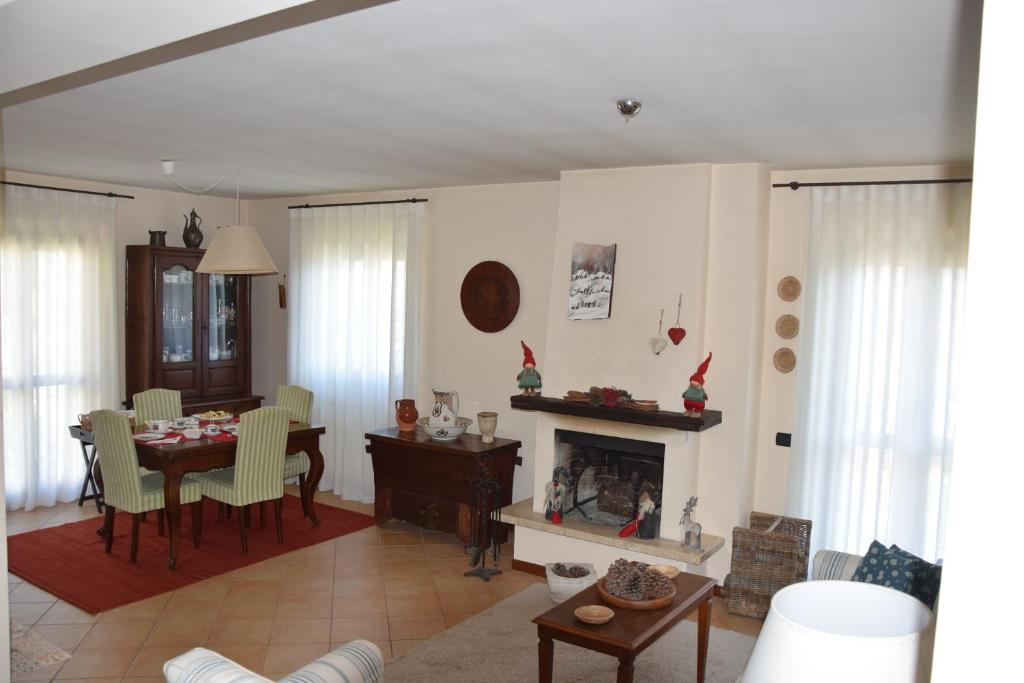 a living room with a table and a fireplace at Casa Palmira in Pescocostanzo