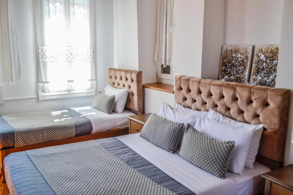 Postel nebo postele na pokoji v ubytování Bozzali Deluxe Hotel