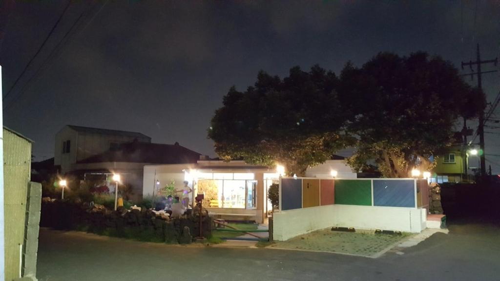 une maison éclairée la nuit avec des lumières dans l'établissement Today Jeju Yongdam, à Jeju