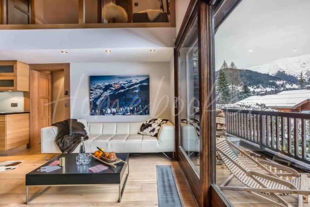 a living room with a couch and a table at Yupik in Megève