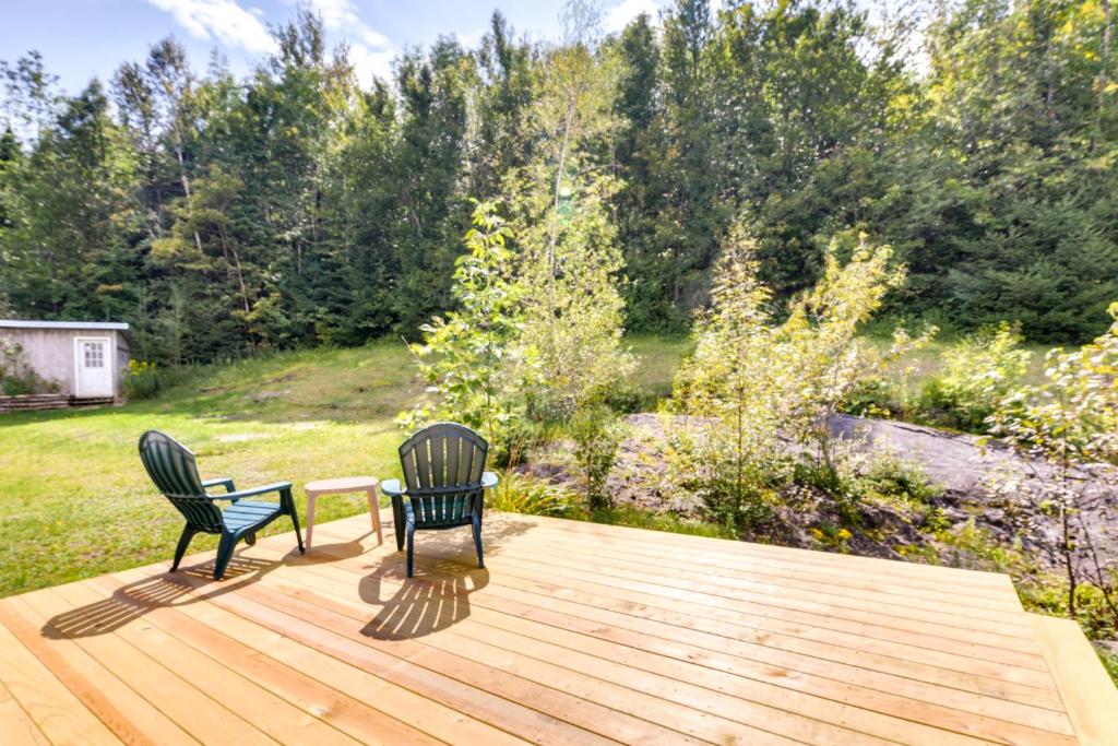two chairs and a table on a wooden deck at Vermont Vacation Rental about 11 Mi to Lake Willoughby in East Charleston