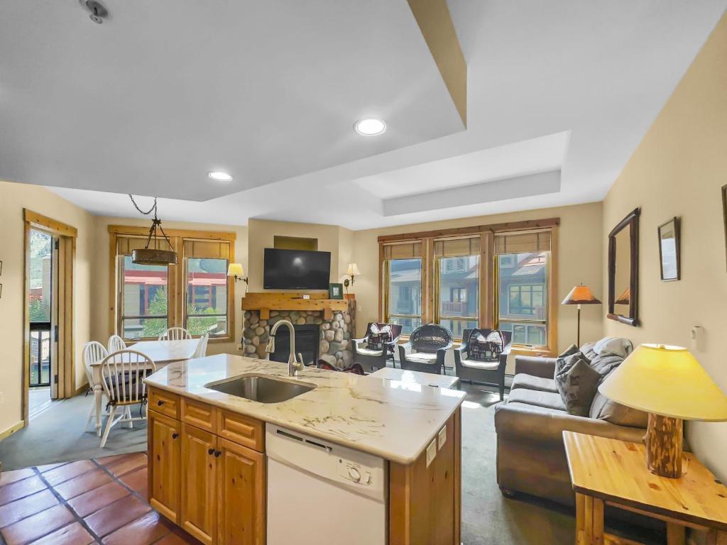 a kitchen and living room with a couch and a table at Tx414 Taylors Crossing Condo in Copper Mountain