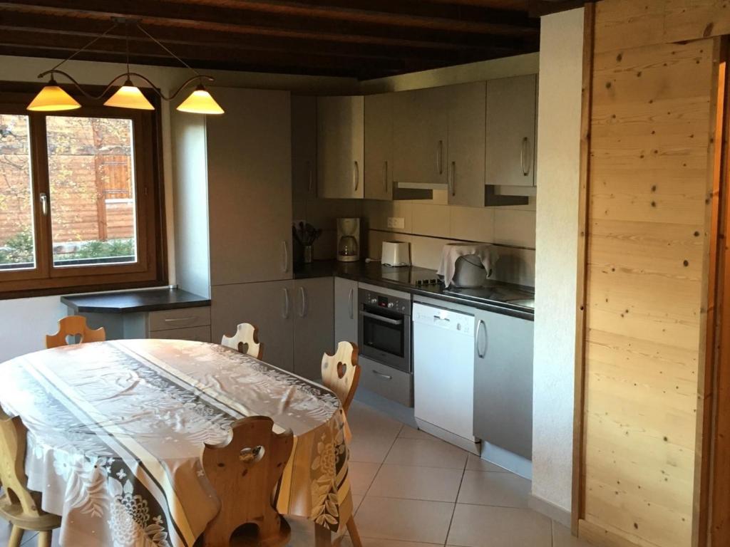 a kitchen with a table and a stove top oven at Appartement Les Gets, 4 pièces, 6 personnes - FR-1-671-99 in Les Gets