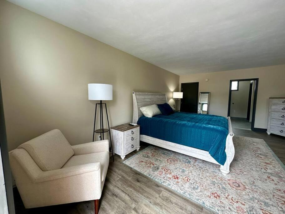 a bedroom with a bed and a chair and a couch at Cozy 1-Bedroom Suite in Sybertsville