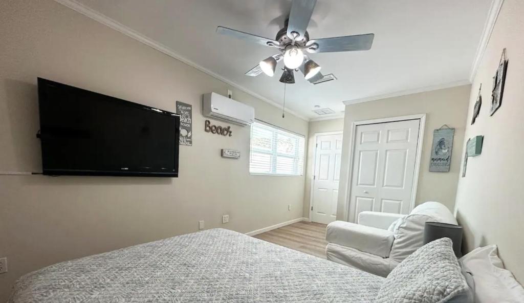a bedroom with a bed and a flat screen tv at Private Suite with Private Gym&Patio, Minutes to Beaches, Up to 4 Guests in Largo