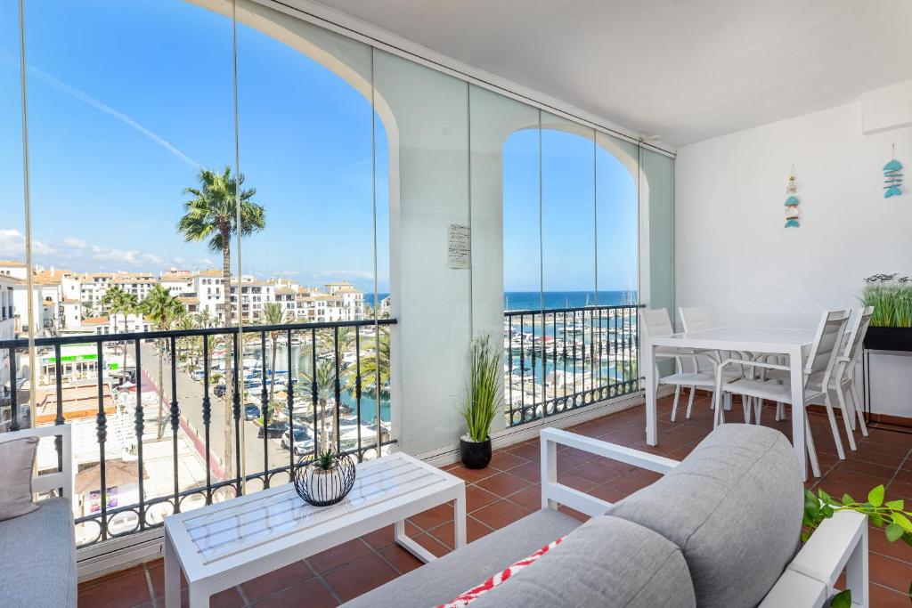 a living room with a balcony with a view of the ocean at Marina Real 2391 in Manilva