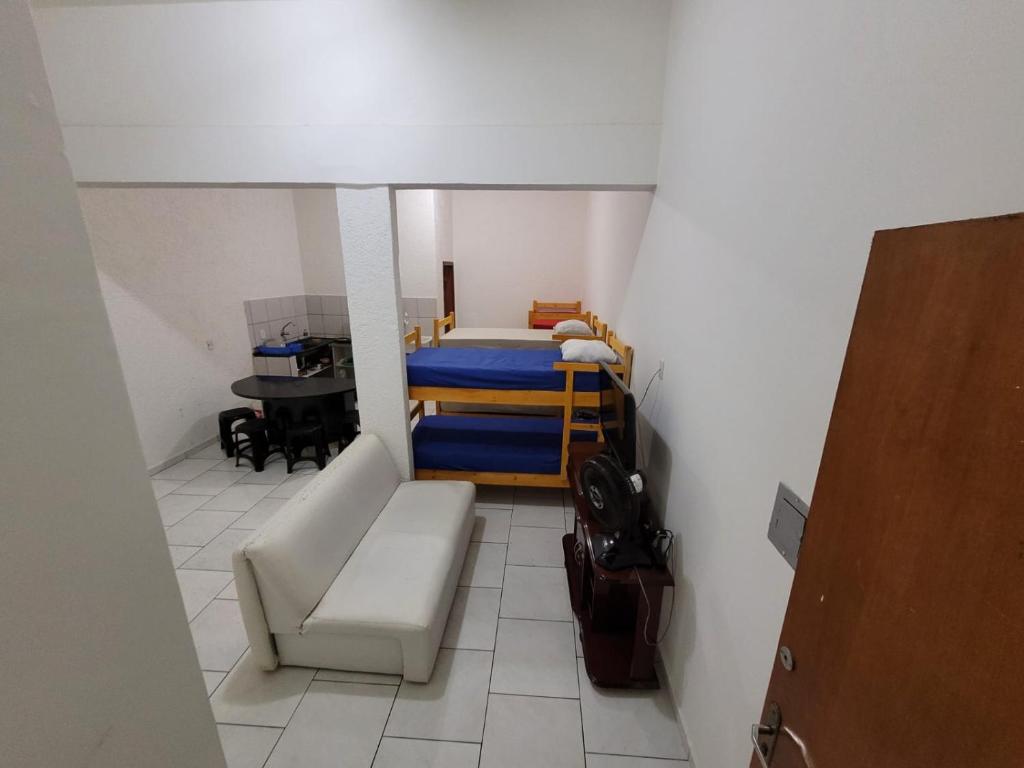 a small room with a bed and a couch at apartamento ADE 101, wifi in Brasilia