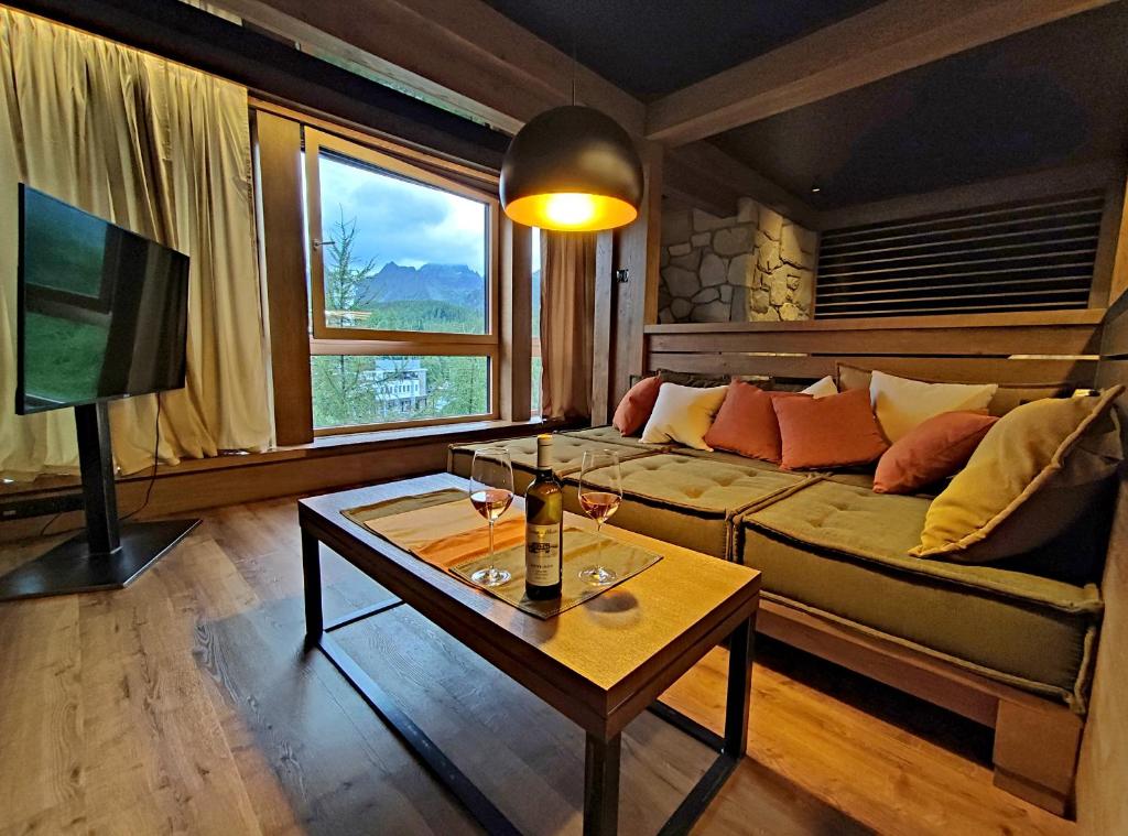 a living room with a couch and a table at Apartman Mary Lou, Hotel Ovruc in Vysoké Tatry