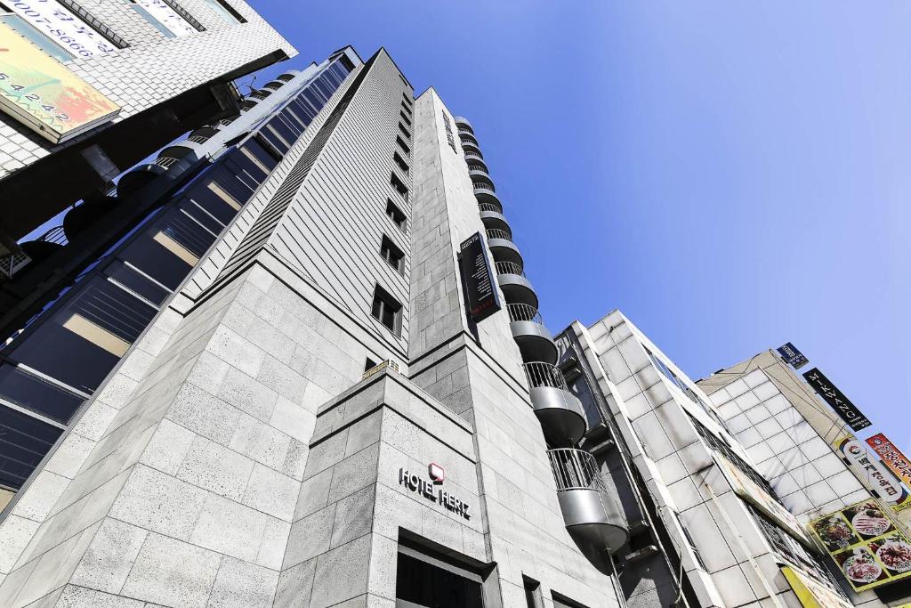 a tall building with a sign on the side of it at HERTZ Hotel in Seoul