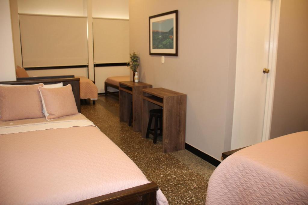 Postel nebo postele na pokoji v ubytování Hotel Plaza El Santuario