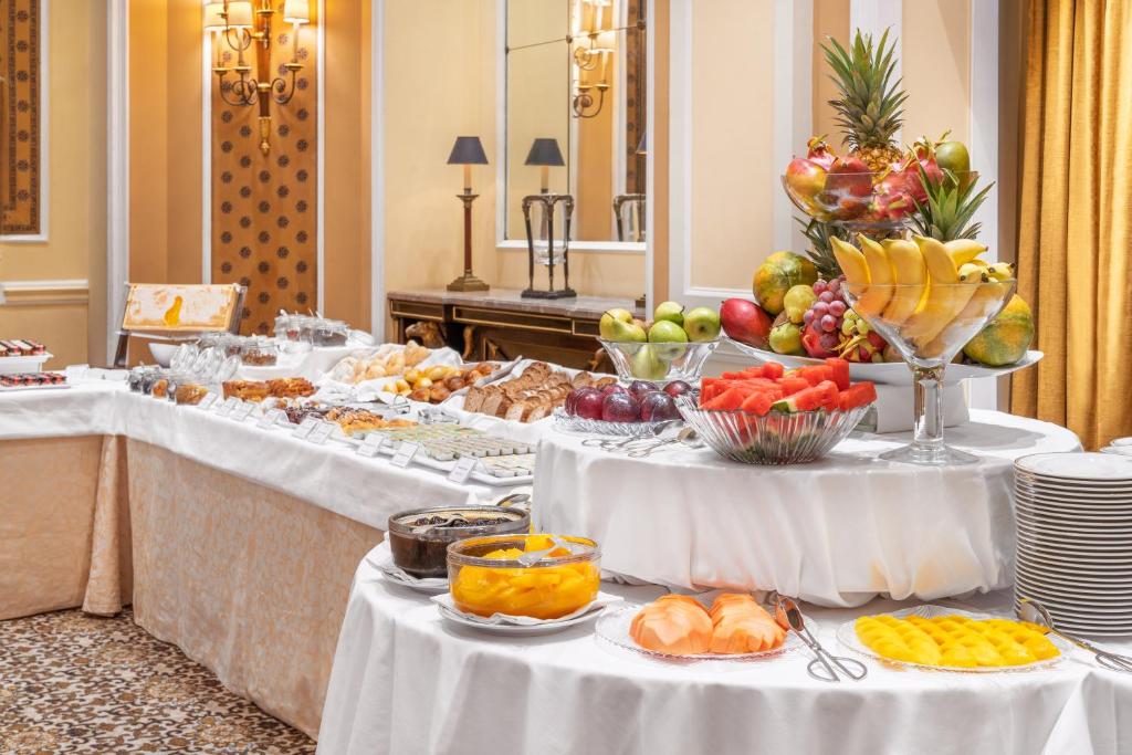 a buffet line with fruits and pastries on tables at Palácio Estoril Hotel, Golf & Wellness in Cascais
