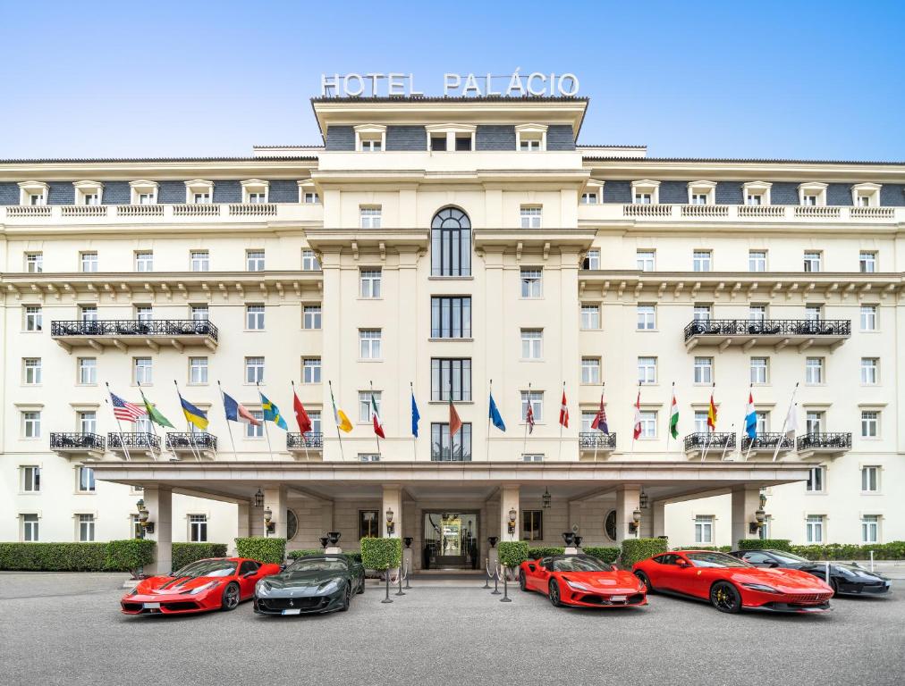 a row of luxury cars parked in front of a hotel at Palácio Estoril Hotel, Golf & Wellness in Cascais