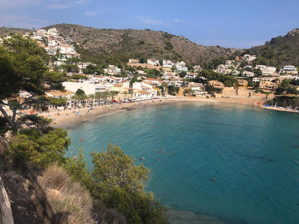 a beach with a bunch of people in the water at Paraíso in Cumbre del Sol