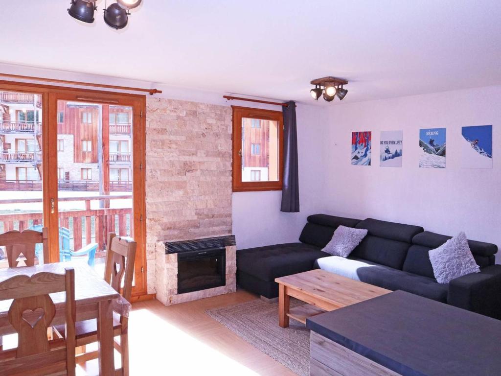 a living room with a couch and a fireplace at Appartement Les Orres, 2 pièces, 8 personnes - FR-1-322-533 in Les Orres