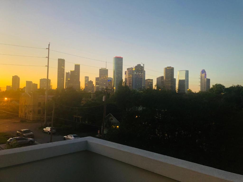 a view of a city skyline at sunset at Moose Manor Guest Suite - Houston in Houston