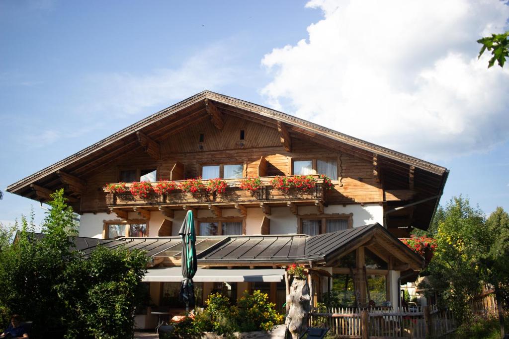 a house with flowers on the front of it at Hotel Forsthof in Sankt Johann im Pongau