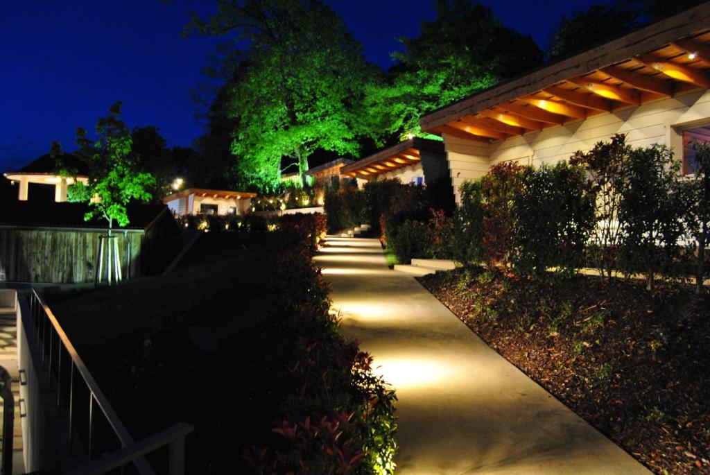a pathway leading to a house at night at Mondorf Parc Hotel & Spa in Mondorf-les-Bains