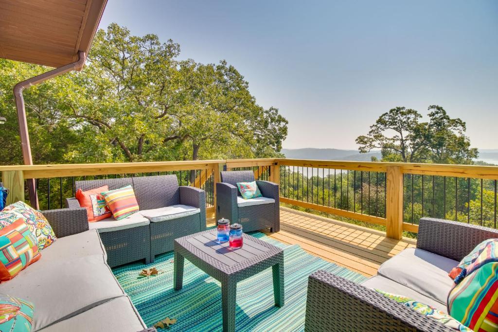 a patio with chairs and a table on a deck at Mountain Home Retreat with Balcony and Lake Views! in Mountain Home