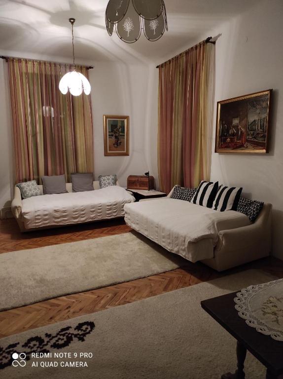 a living room with two beds and a couch at Issy Apartment in Sarajevo