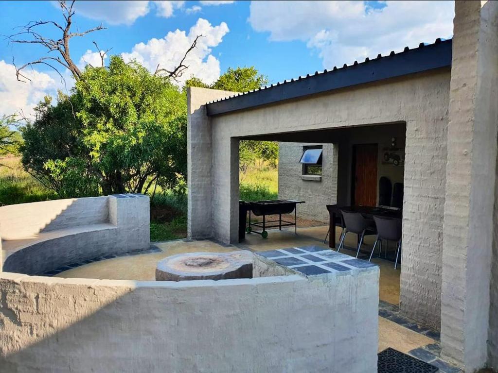 a patio with a fire pit and a table at Horizon Savannah in Dinokeng Game Reserve