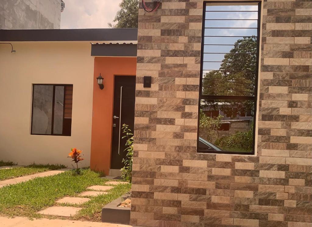 a house with a brick wall and a window at Casa privada, ubicada cerca del centro histórico de Santa Ana in Santa Ana