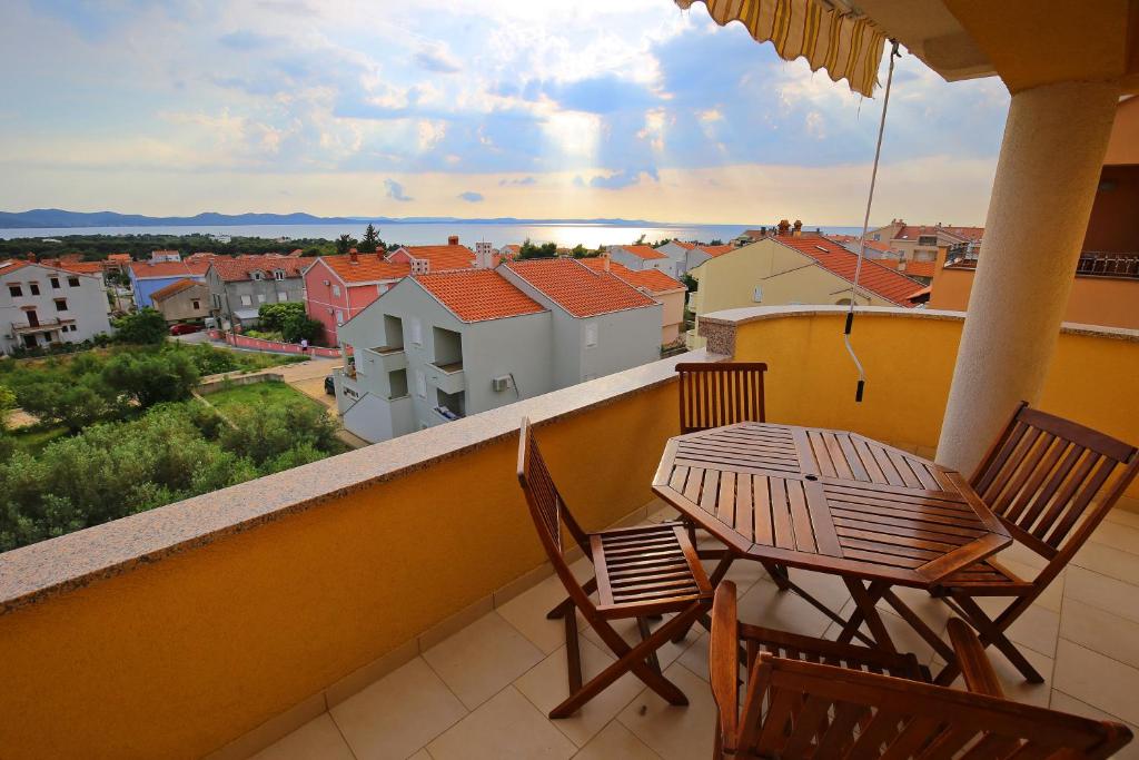 a balcony with a table and chairs and a view at Villa Zubčić in Zadar