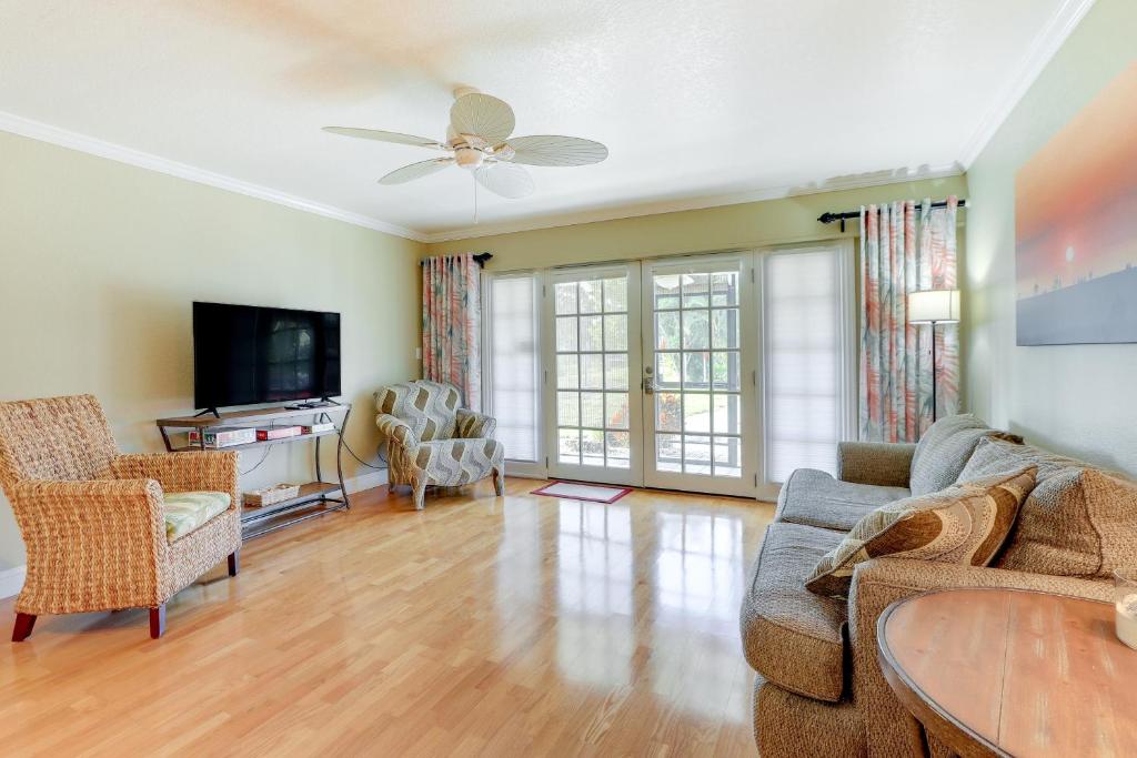 a living room with a couch and a tv at Welcoming Sarasota Vacation Rental with Pool! in Sarasota