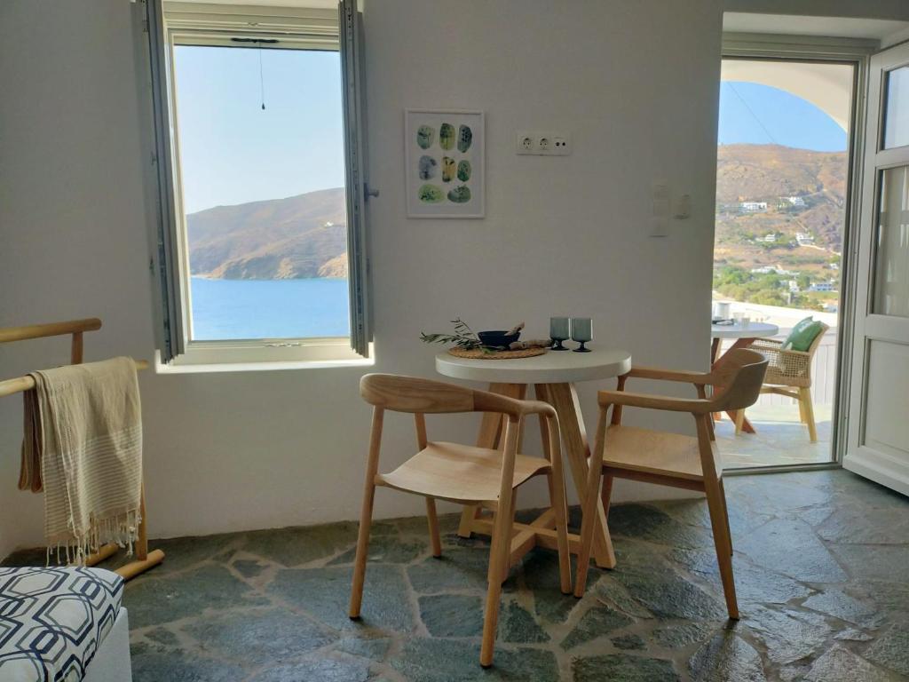 a room with a table and two chairs and a window at Amorgos Elegant Houses, 6 Villas in Amorgos