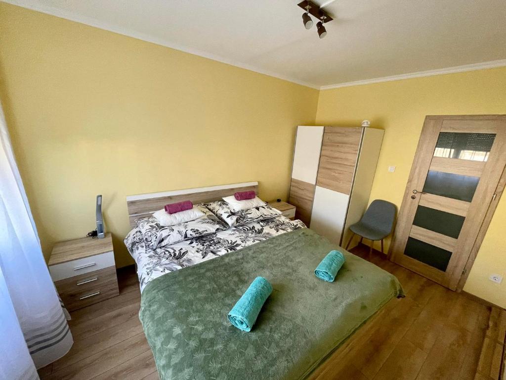 a bedroom with a bed with two pillows on it at LOVEly Home&Lake in Balatonfüred