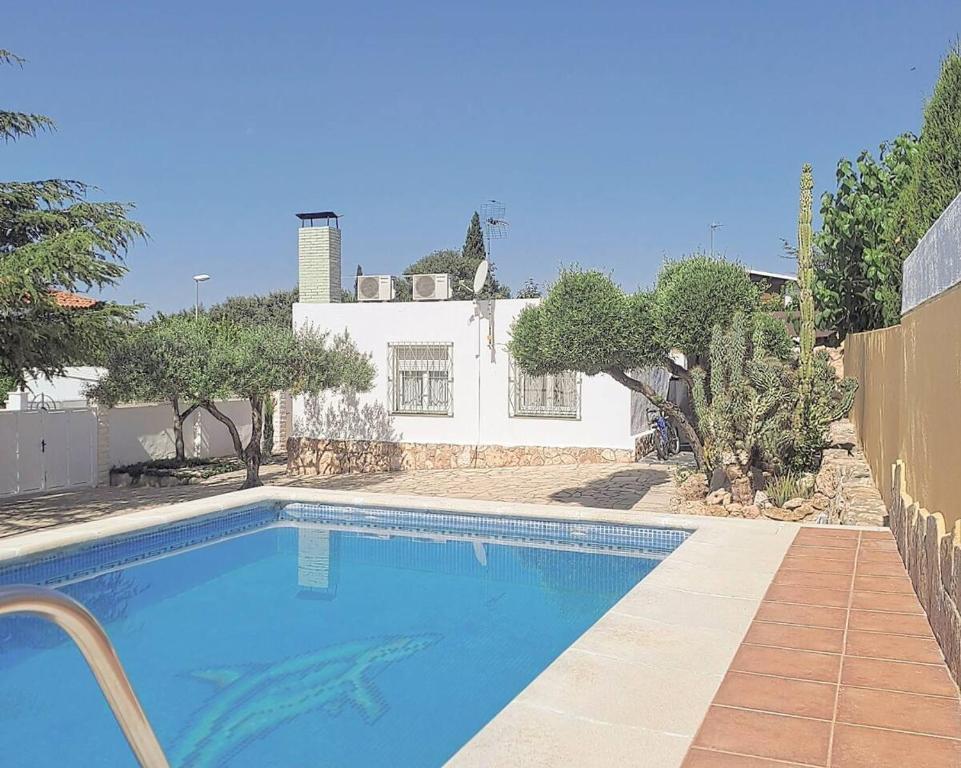 a swimming pool in front of a house at Casa con piscina y barbacoa in Catllar